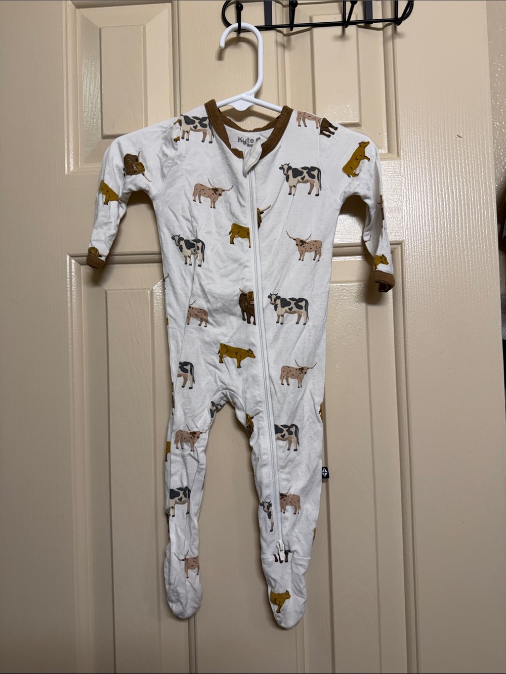 Kyte BABY White Footed One-Piece with Cow Print and Brown Trim